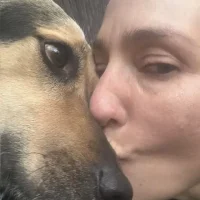 The founder of High Park Pet Care having a loving moment with a beautiful Beagkle dog